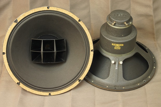 Two vintage coaxial loudspeakers, one facing forward and one showing its magnet and basket
